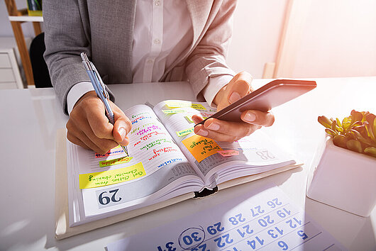 Person Hands With Mobile Phone And List Of Work Planning and Managing