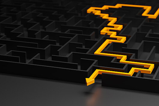 3d rendering: Concept - solving a complex problem. Black maze and floor with yellow solution path with arrow. Low key image.